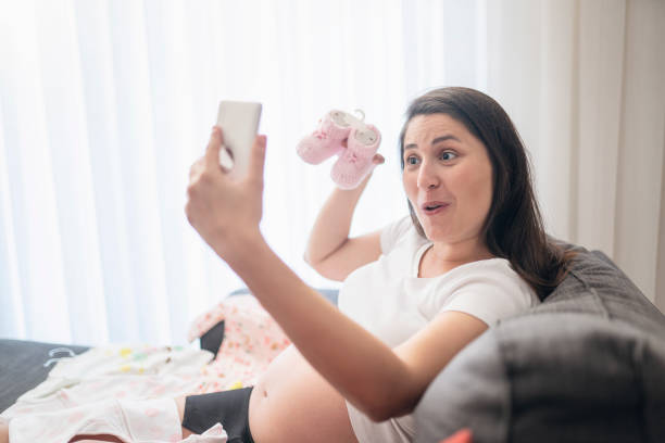 istock Baby clothes, taking photo 1191892911