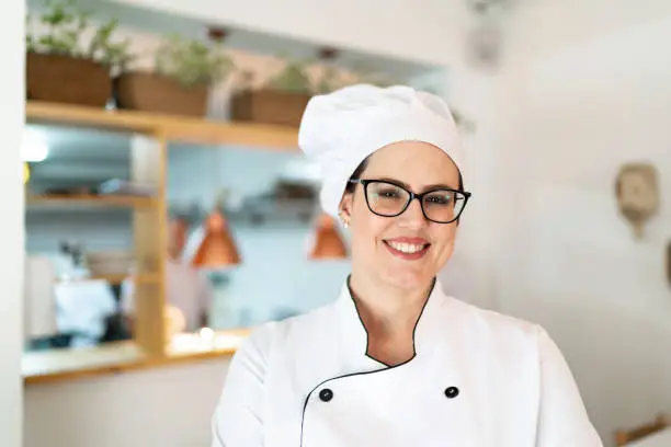 Portrait of a smiling woman chef at restaurant