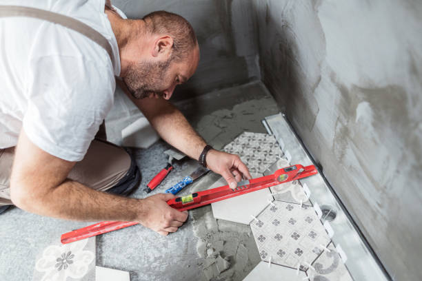 istock Tiler measuring and leveling the bathroom floor 1191895530