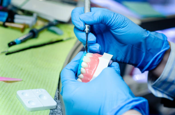 istock Close-up of denture manufacturing process. Tooth reconstruction. 1191895666