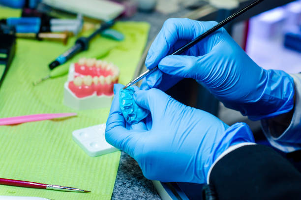 istock Close-up of denture manufacturing process. Tooth reconstruction. 1191895719