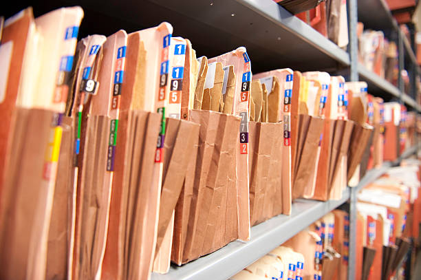 istock Old fashioned file folders on a metal shelves 119189647