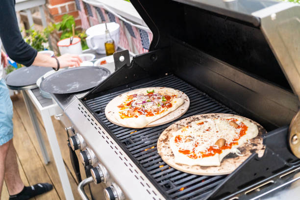 Preparing individual grilled pizzas