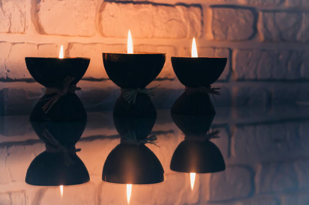 istock Burning spa aroma candles in coconut shell on a glass white table, cozy home interior 1191900340