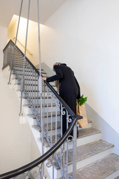 istock Old lady returns home after food shopping 1191901557