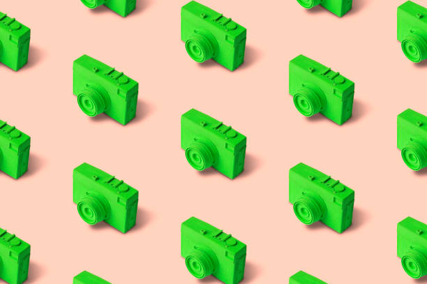 Green retro photo camera seamless pattern on pastel background.