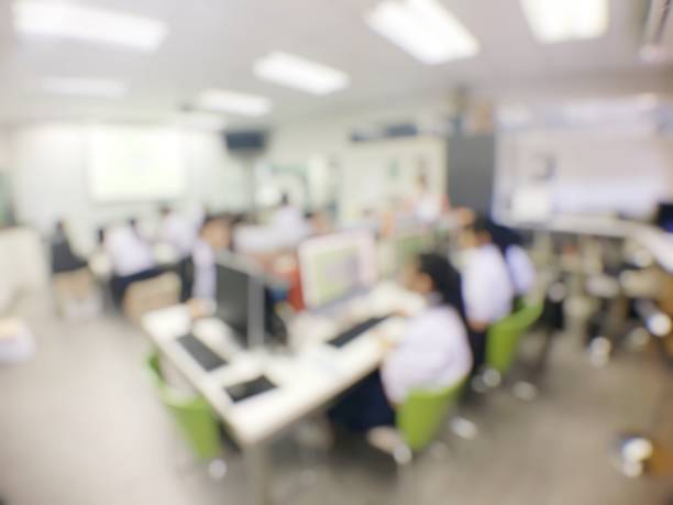 istock Blurred image of group of students are learning and sitting at desk using computer lap together in classroom for study and workshop in computers room at secondary school. education technology concept. 1191904296