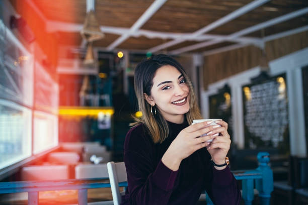 istock happy women drinking tea - coffee 1191904329