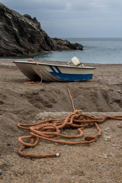 istock Small boat and its rope on the beach 1191904471