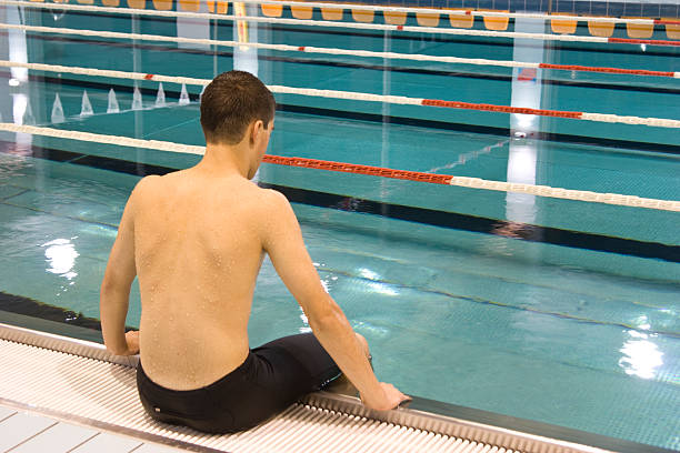istock Swimmer sitting on edge of the pool 119190459