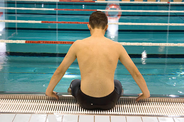 istock Swimmer sitting on edge of the pool 119190466