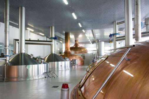 brewery workshop with copper and stainless fermentation vats