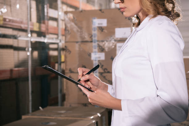 istock partial view of storekeeper writing on clipboard in warehouse 1191908878