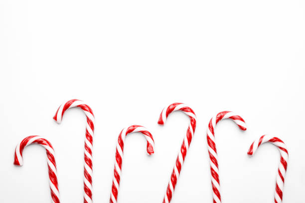 istock Frame made with Christmas candy canes on white background. Minimal composition with peppermint candies. Flat lay, top view with space for text 1191910300