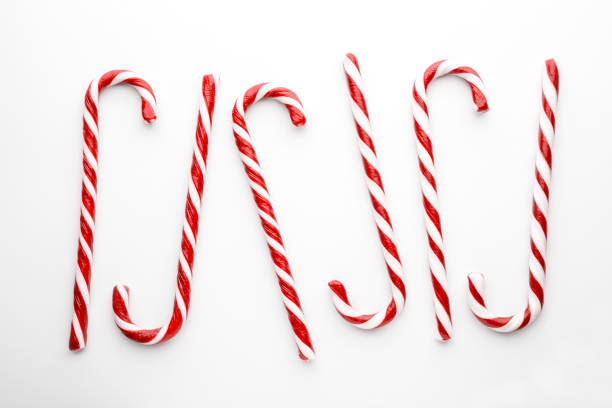 istock Christmas candy canes on white background. Minimal composition with peppermint candies. Flat lay, top view 1191910319