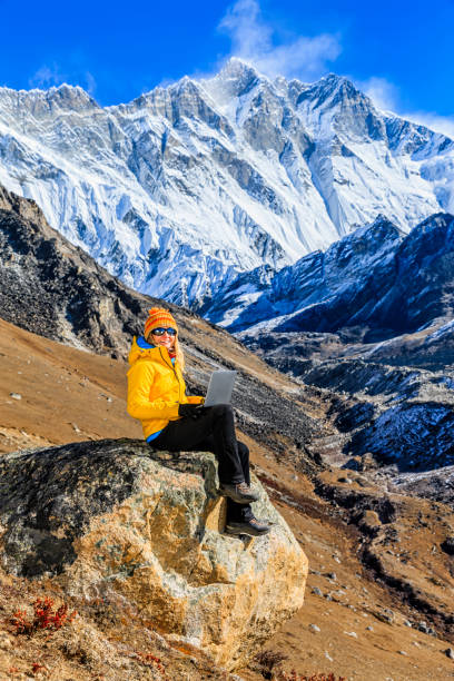 istock Young woman using laptop in Himalayas, Nepal 1191910961