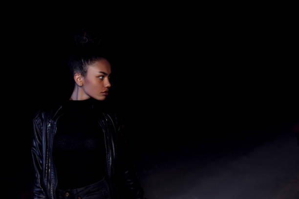 istock Young African Woman Walking in Darkness 1191913738