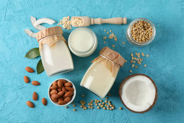 istock Composition with different types milk, coconut, soybeat seets, almound, oatmaet on blue background, space for text. Top view 1191913772