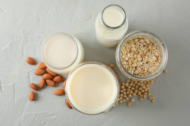 istock Bootle and glass of different types milk on gray background, space for text. Top view 1191913839
