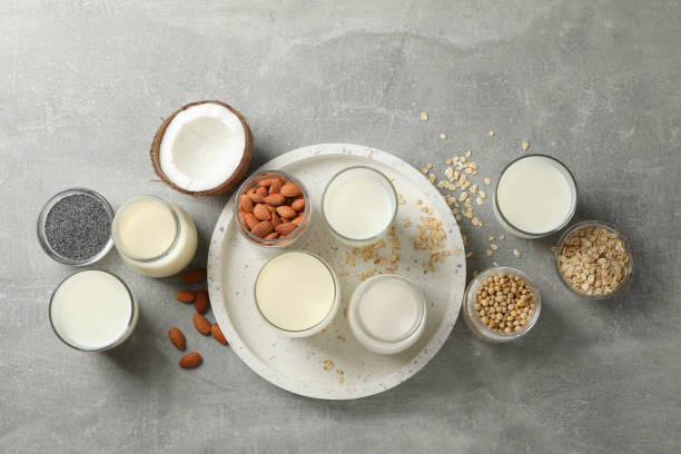 istock Bottle and glass of different types milk on grey background, space for text. Top view 1191913898