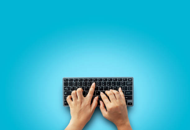 istock Top view of female hands on modern computer keyboard. Isolated over on blue background, Simple design, blank copy space for your designs 1191915351