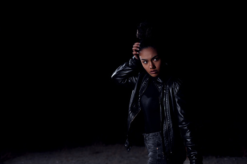 Fashionable young African woman in leather jacket.