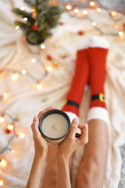 istock Feet in Santa's socks near the Christmas tree 1191915523