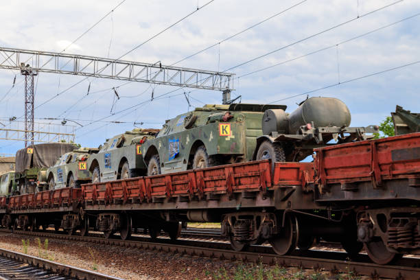 istock Cargo train carrying military vehicles on railway flat wagons 1191921012