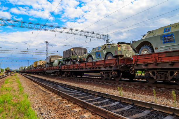 istock Cargo train carrying military vehicles on railway flat wagons 1191921013