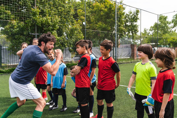 istock Coach encouraging kids on a soccer field 1191922281