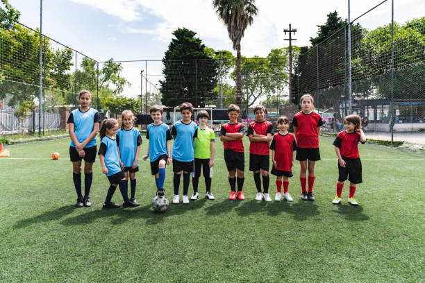 istock Two mixed soccer teams in a row together 1191922379