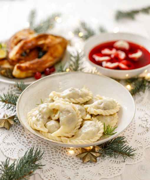 istock Dumplings, Christmas dumplings stuffed with forest mushrooms and cabbage on a white plate on a holiday table 1191928359