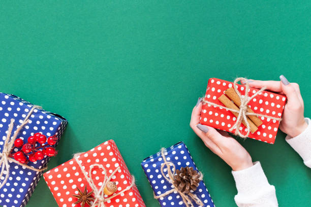 istock Background with female hands holding a gift box 1191930957