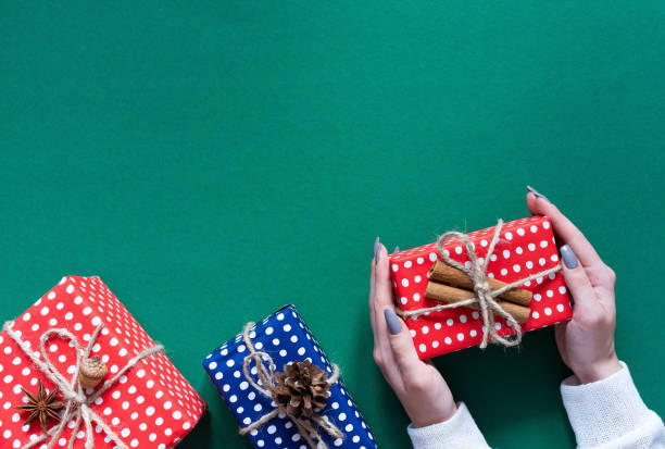istock Background with female hands holding a gift box 1191930960