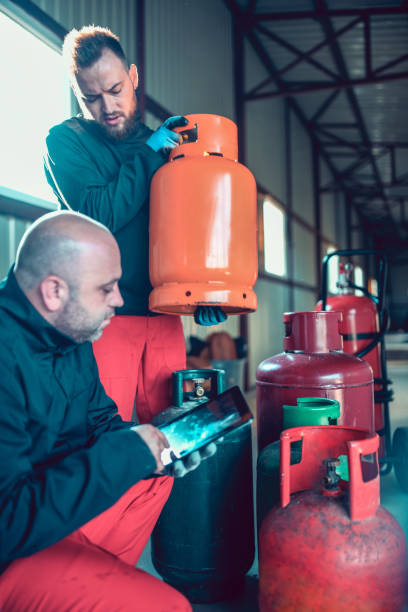 istock Two Males Recording Gas Cylinder Arrival Dates 1191931253