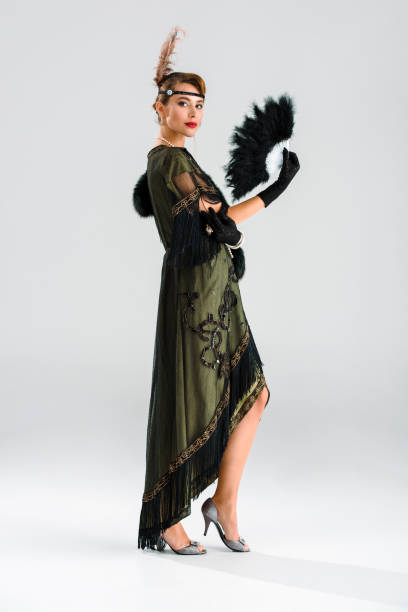 istock attractive and aristocratic woman holding feather fan on grey 1191932326