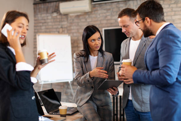istock Group of young business people communicate in the office 1191932501