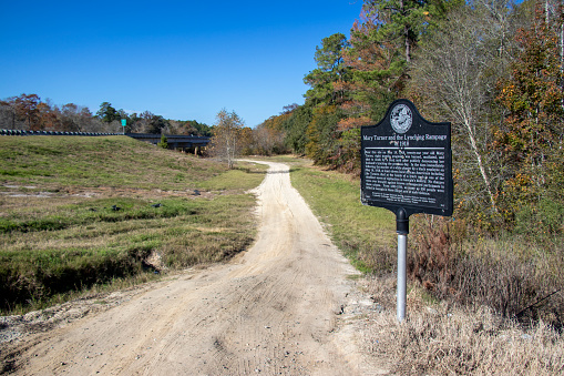 Hahira, Georgia - November 30, 2019: A bullet-riddled sign marks the spot near the Little River where Mary Turner was murdered by a local mob in 1918 after denouncing her husband's lynching.
