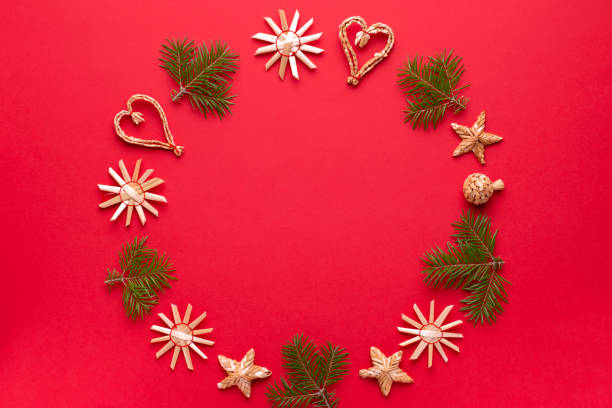 istock Christmas natural wood decorations and pine tree frame on red background, copy space. Flat lay, christmas card with ornaments from ecological materials, top view 1191935387