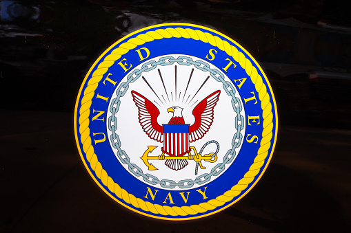 San Diego, Navy pier, California, UNITED STATES - August 3, 2018: Emblem of the United States Navy isolated on a door of black car of United States Armed Forces.