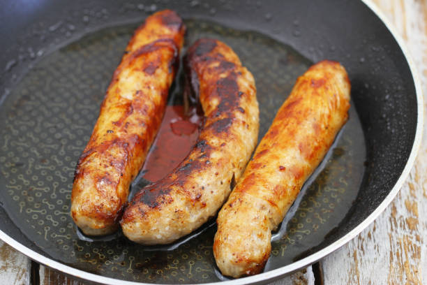 istock Three fried British pork sausages in frying pan 1191935790
