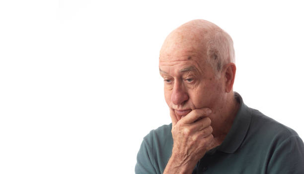Senior man on white wearing green polo suffer from headache