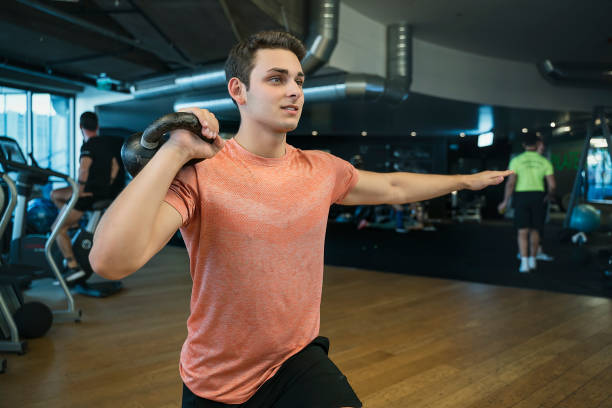 istock Male fitness instructor building muscles with kettle 1191936726