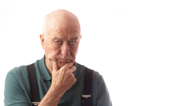 istock Senior man on white wearing green polo looking inquisitive 1191936879