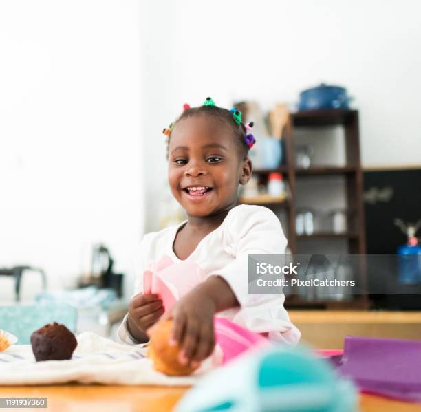 Happy Smiling 2 Year Old Girl Taking A Muffin Stock Photo - Download Image Now - Muffin, 2-3 Years, African Ethnicity