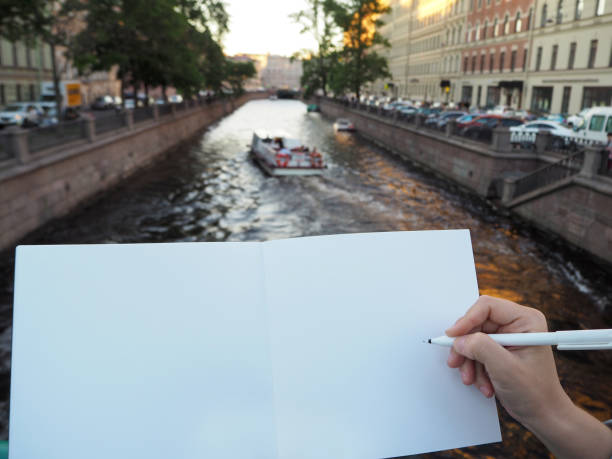 istock Mockup of person's hand holding blank white notebook preparing to write down his or hers ideas. 1191937409