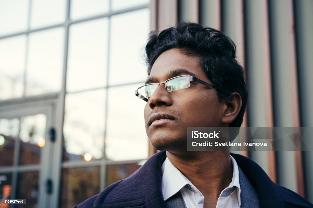 Young Handsome Indian Man In An Office Suit And White Shirt With Glasses  Stock Photo - Download Image Now - iStock