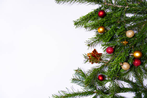 istock Green fir branches with Christmas ornaments (Christmas baubles, candy canes, presents) on white background 1191938073