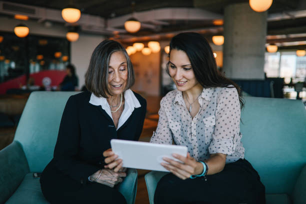 istock Senior manager discussing work with younger colleague on a digital tablet 1191953656