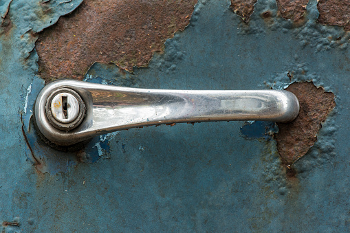 Rusty plumb tube on rusty metal wall background